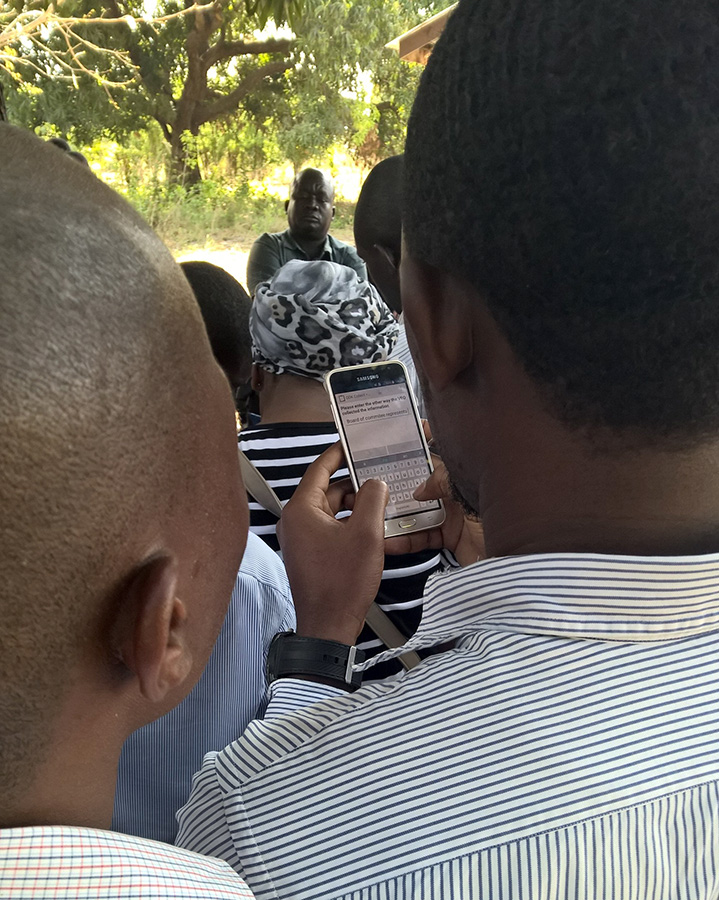 Enumerators interviewing the VEO (Village Executive Officer) during the pilot exercise, using ODK Collect: